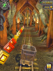 Screenshot fra Temple Run 2 - der vises en lille vogn på skinner i en mine